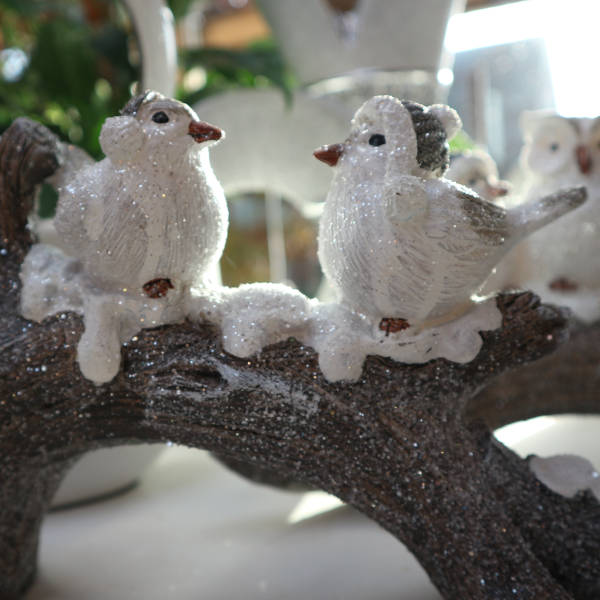 Dekorationsfigur: Zwei weiße Vögelchen sitzen auf einem mit Schnee bedeckten Ast.
